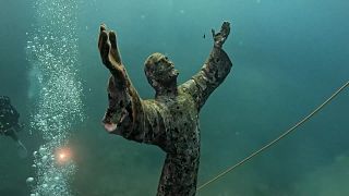 Underwater Christ statue in Liguria cleaned by divers