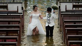 Typhoon fails to stop wedding in flooded church in Philippines