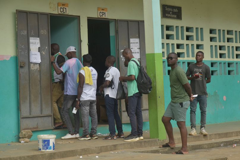 Voters queue up to vote during the Presidential elections at a polling station in Cocody, Ivory Coast, Saturday, Oct. 25, 2025.